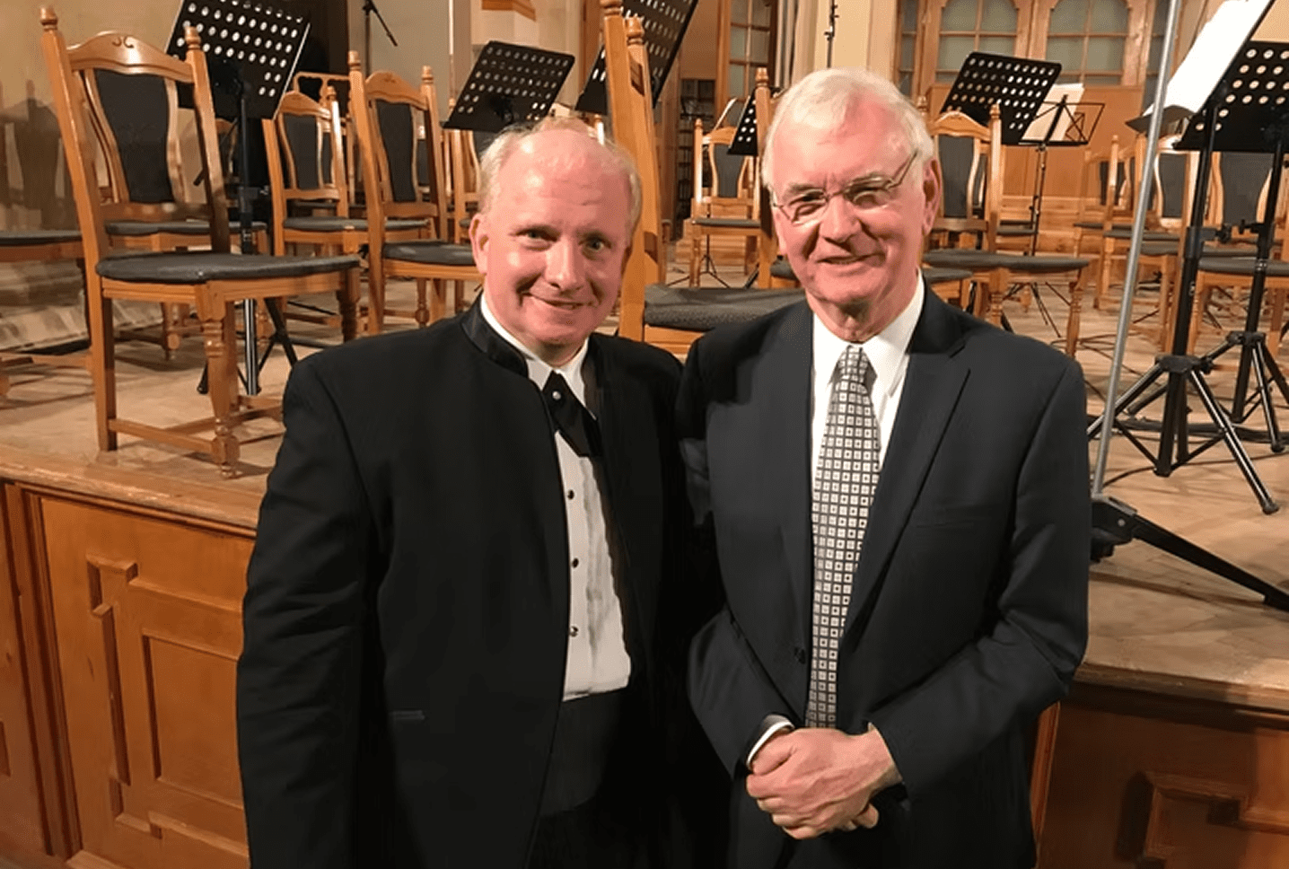 Smiling men posing on a stage