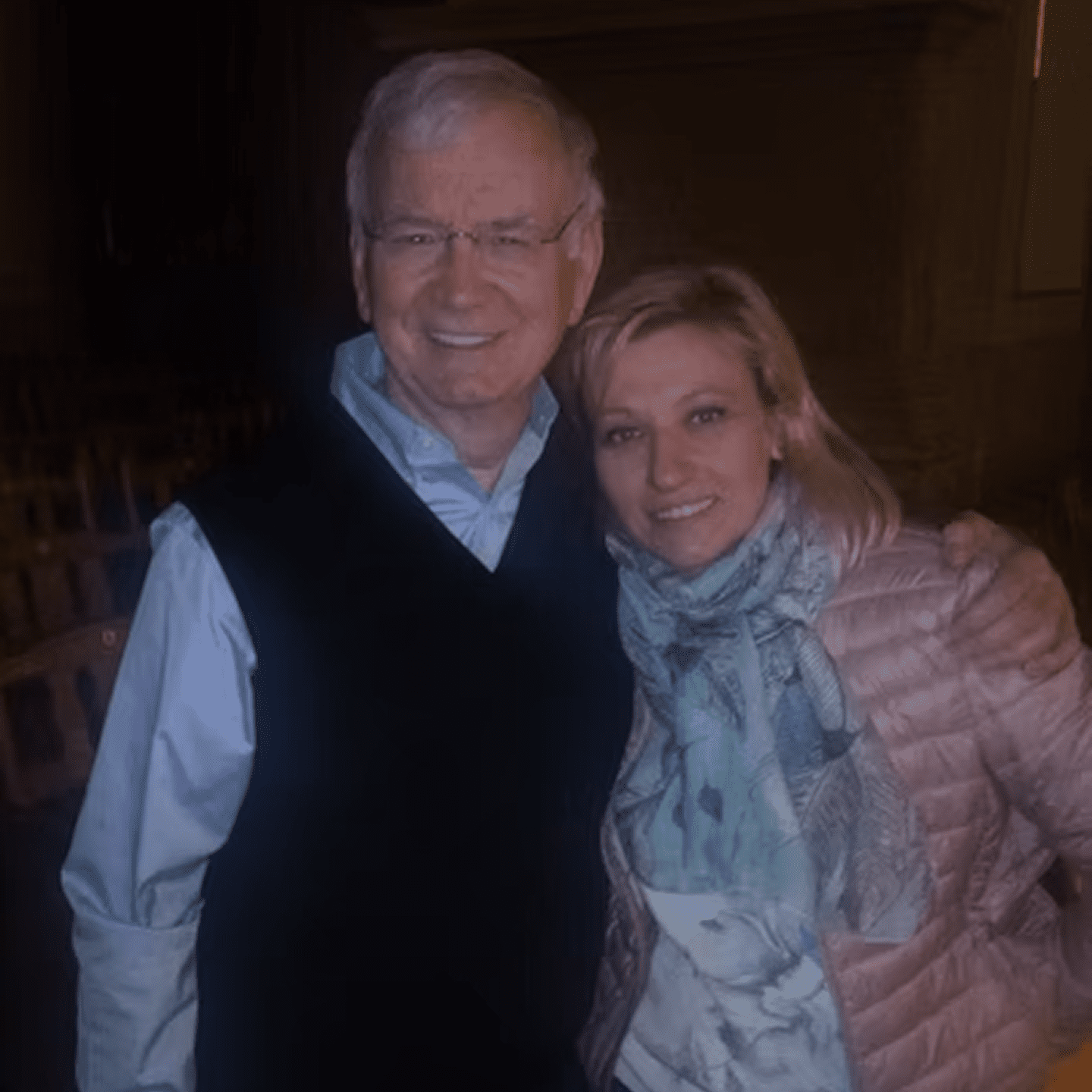 Smiling pair in dimly lit room